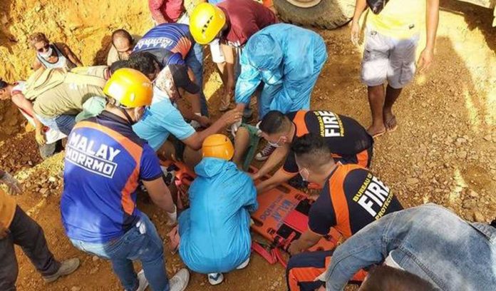 region-caticlan-landslide Rescuers put on a stretcher a man they pulled out from a landslide-hit area in Sitio Putol, Barangay Caticlan, Malay, Aklan on Saturday. MALAY, AKLAN BFP PHOTO