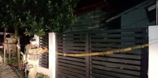 A policeman removes the barrier tape cordoning the house of a frontliner under quarantine in Barangay Calala, Hamtic, Antique. PHOTOS FROM FACEBOOK PAGE OF MAYOR JUNJUN PACIFICADOR