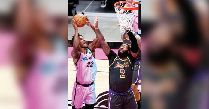 sports-banner Miami Heat’s Jimmy Butler (22) attempts for a basket while Los Angeles Lakers’ Andre Drummond (2) defends during the second half of their 2020-2021 NBA Season match, April 8, at American Airlines Arena in Miami, Florida. MARTA LAVANDIER/AP