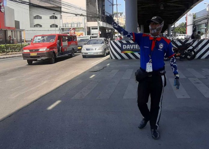 traffic-aide A traffic enforcer directs the flow of vehicles and pedestrians in Molo, Iloilo City. The city will now fully compensate traffic auxiliaries for their 26 days of duty every month. However, some of them will be retrenched. JAPHET FAJARDO/PN