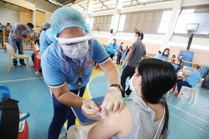A frontliner from the Iloilo City Hall receives her second dose of the CoronaVac vaccine against coronavirus disease 2019. This week, the city government will inoculate its elderly and immunocompromised residents. ARNOLD ALMACEN/CMO