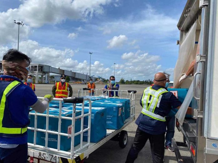 vaccine-delivery Workers unload boxes that contain jabs against coronavirus disease 2019 from an aircraft at Iloilo International Airport in Cabatuan, Iloilo on March 30. Starting next month, Vaccine Czar Carlito Galvez Jr. says the country will expect an accelerated delivery of vaccines. JERRY TREÑAS/FACEBOOK