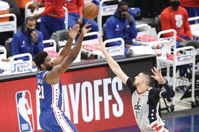 Philadelphia 76ers’ Joel Embiid (21) shoots against Washington Wizards’ Alex Len (27) during the first half of Game 3 of NBA’s first-round basketball playoff series on Saturday. AP PHOTO/NICK WASS