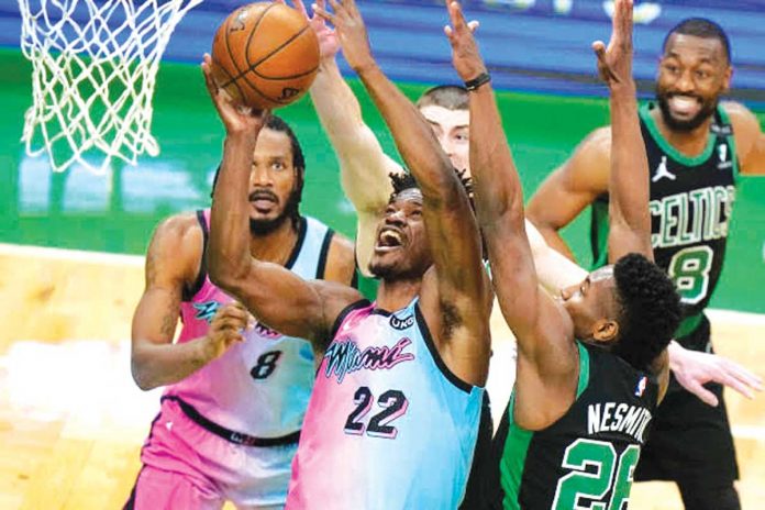 MIAMI-HEAT-HOLDS-OFF-BOSTON-CELTICS Miami Heat’s Jimmy Butler (22) drives towards the basket past Boston Celtics’ Aaron Nesmith, right, as Heat’s Trevor Ariza (8) looks on in the second half of a basketball game in Boston. PHOTO BY AP PHOTO/STEVEN SENNE