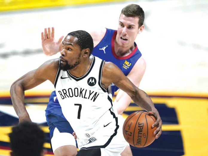 Sports-1-banner Brooklyn Nets’ Kevin Durant (7) escapes the defense of Denver Nuggets’ Vlatko Cancar during the second half of their basketball game in Denver, Colorado. The Nets snapped their four-game losing streak after a 125-119 win over the Nuggets. AP PHOTO/DAVID ZALUBOWSKI