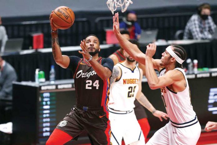 Sports-1-banner THE OREGONIAN. Portland Trail Blazers wing Norman Powell (24) drives to the basket against Denver Nuggets forward Aaron Gordon (right) during their NBA basketball game on Sunday. The Nuggets suffered a 132-116 defeat to the Trail Blazers.