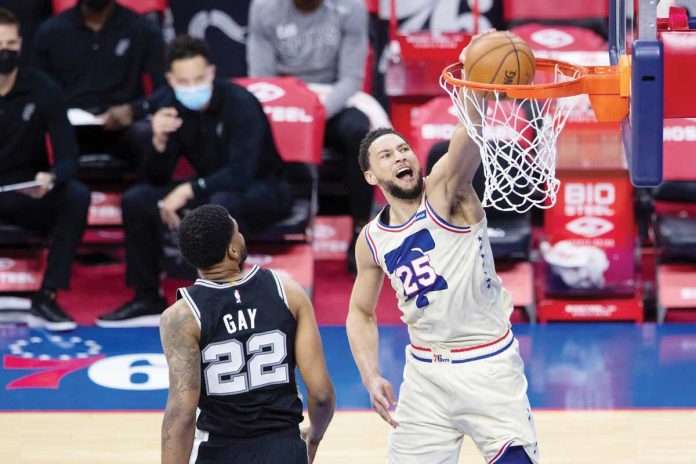 Philadelphia 76ers' Ben Simmons (25) dunks past Rudy Gay (22) of San Antonio Spurs during their basketball game on Sunday at the AT&T Center in San Antonio, Texas. MITCHELL LEFF/GETTY IMAGES Philadelphia 76ers' Ben Simmons (25) dunks past Rudy Gay (22) of San Antonio Spurs during their basketball game on Sunday at the AT&T Center in San Antonio, Texas. MITCHELL LEFF/GETTY IMAGES