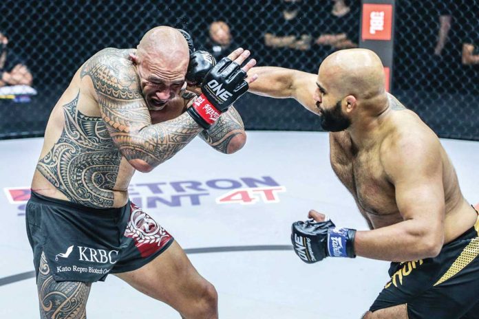 Sports-3 Filipino-American mixed martial arts fighter Brandon Vera (left) gets a right hook hit from Arjan Bhullar of India (right) during the ONE: Dangal fight in Singapore. ONE PHOTO