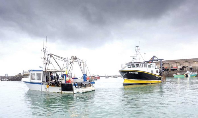 World-1 French fishing vessels block the port of St. Helier in Jersey, Thursday, May 6, 2021. French fishermen angry over loss of access to waters off their coast have gathered their boats in protest off the English Channel island of Jersey. GARY GRIMSHAW/BALLIWICK EXPRESS VIA AP