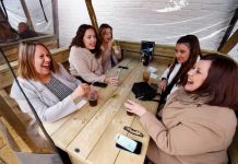 Customers at a pub enjoy drinks, as lockdown eases amid the coronavirus disease 2019 pandemic, in Northwich, Cheshire, Britain. REUTERS/JASON CAIRNDUFF