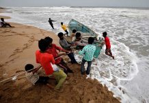 People move a fishing boat to a safer place along the shore ahead of Cyclone Tauktae in Veraval in the western state of Gujarat, India. REUTERS/AMIT DAVE