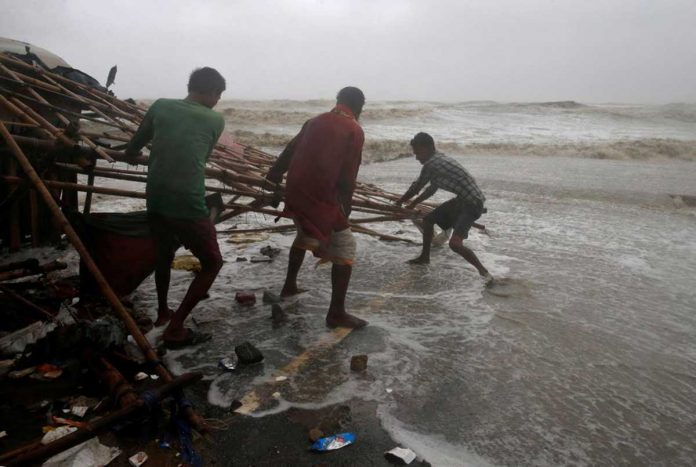Men remove bamboo rooftop of a stall damaged by heavy winds at a shore ahead of Cyclone Yaas in Bichitrapur in Balasore district in the eastern state of Odisha India. REUTERS/RUPAK DE CHOWDHURI Men remove bamboo rooftop of a stall damaged by heavy winds at a shore ahead of Cyclone Yaas in Bichitrapur in Balasore district in the eastern state of Odisha India. REUTERS/RUPAK DE CHOWDHURI