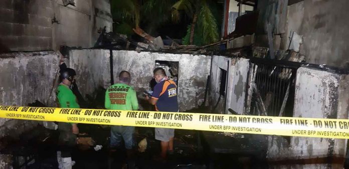 arevalo-fire Firefighters secure the area where a blaze broke out in Barangay Calaparan, Arevalo, Iloilo City on Saturday, May 22, 2022. A house was totally gutted while one was damaged. JAP FAJARDO/PN