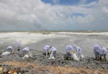 Members of the Sri Lankan navy remove debris from a beach in Negombo, Sri Lanka. REUTERS