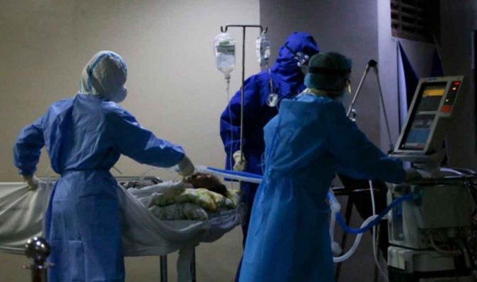 covid-cases-dip A COVID-19 patient on a mechanical respirator is wheeled out by health personnel to another room for dialysis treatment in UP-Philippine General Hospital, Manila. INQUIRER PHOTO/LYN RILLON
