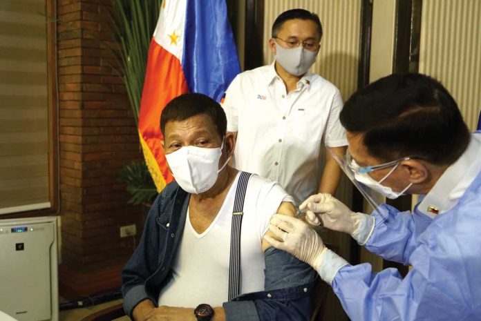 du30 President Rodrigo Duterte gets his initial dose of the Sinopharm vaccine against coronavirus disease 2019 with Health secretary Francisco Duque III administering the shot. PHOTO COURTESY OF SEN. BONG GO