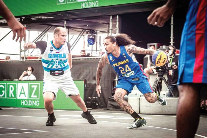 gilas-Pilipinas Gilas Pilipinas 3x3’s Joshua Munzon attempts to evade Slovenia’s defense during their basketball match in the 2021 FIBA 3×3 Olympic Qualifying Tournament in Austria. FIBA