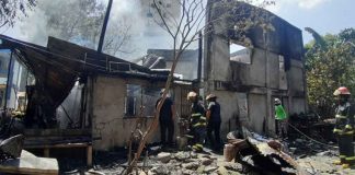 Fire investigators check the area where a blaze broke out past noon yesterday, May 24. JAP FAJARDO/PN