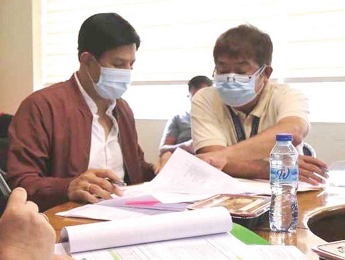 mayor-dadivas Mayor Ronnie Dadivas (left) of Roxas City goes over the details of the proposed upgrading of the city’s slaughterhouse.