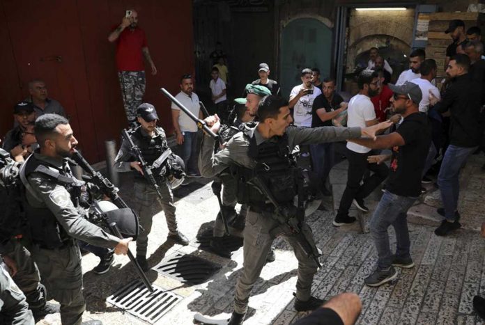 palestinians Israeli police and Palestinian protesters clash in Jerusalem's Old City on Tuesday. AP PHOTO/MAHMOUD ILLEAN