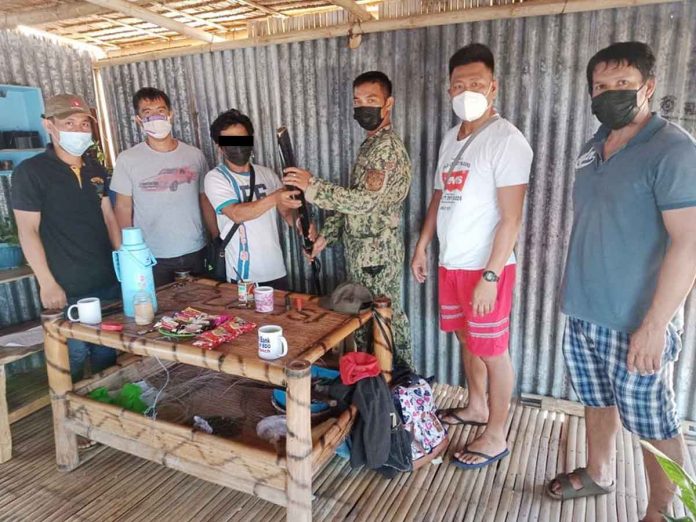 Alyas Anak (3rd from left) surrenders to authorities in Barangay Caridad, Culasi, Antique on May 24, 2021. PHOTO FROM CULASI MPS