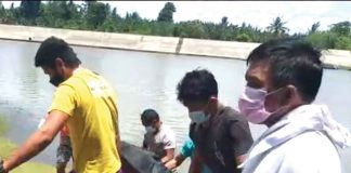 Rescuers retrieve the body of a fisherman who went missing after a large vessel hit the small fishing boat he was in with two other fishermen-friends.