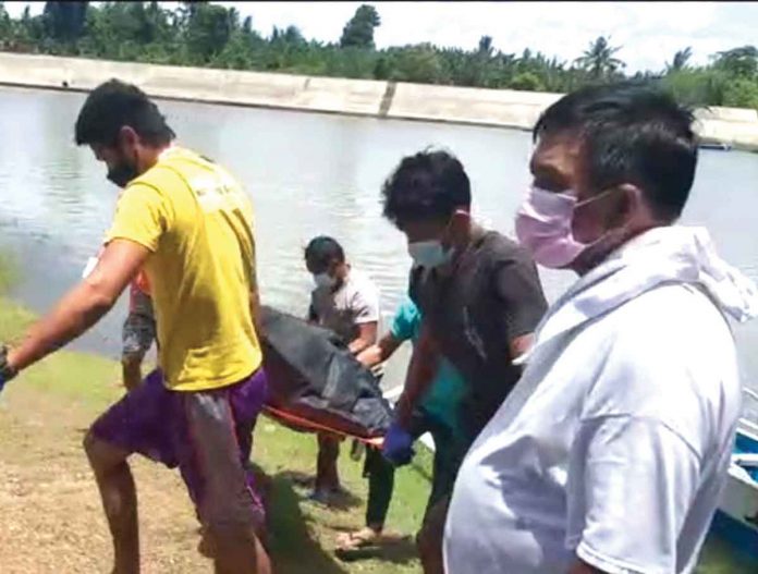 Rescuers retrieve the body of a fisherman who went missing after a large vessel hit the small fishing boat he was in with two other fishermen-friends.