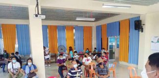 Mayor Eugenio Reyes of Buenavista, Guimaras and Dr. Grace Cortez, municipal health officer, discuss with barangay captains new health protocols. Photo from Buenavista LGU