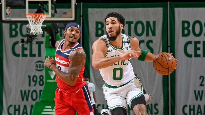 Boston Celtics' Jayson Tatum (right) escapes the defense of Washington Wizards' Bradley Beal (left) during their basketball game on Tuesday. Tatum scores 50 points as the Celtics secured a playoffs seat in the 2020-2021 NBA season. NBA.COM PHOTO