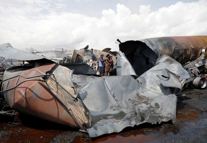 truck-fire Men inspect wreckages of fuel tankers and trucks after an overnight fire, on the outskirts of Kabul, Afghanistan on May 2, 2021. REUTERS/MOHAMMAD ISMAIL