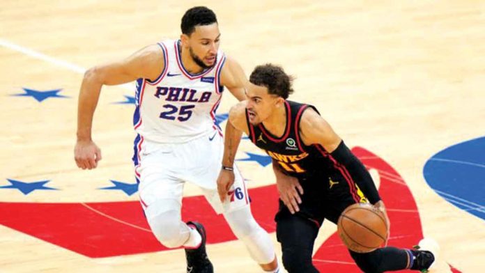 76ers-bow-down-hawks Atlanta Hawks’ Trae Young (11) attacks the defense of Philadelphia 76ers' Ben Simmons (25) during their Game 7 match on Sunday. The Hawks tallied 103-96 to advance to the Eastern Conference finals. AP
