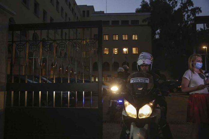 A police officer on a motorcycle exits the Petraki Monastery in Athens, Greece, following an attack with a caustic liquid on Wednesday. Seven Greek Orthodox bishops have been hospitalized after allegedly being attacked with caustic liquid by a priest facing a disciplinary hearing. AP PHOTO/PETROS GIANNAKOURIS