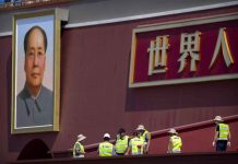 China prepares for Communist Party centenary in secret Workers prepare a raised seating area near the large portrait of Chinese leader Mao Zedong on Tiananmen Gate near Tiananmen Square in Beijing, China. AP PHOTO/MARK SCHIEFELBEIN