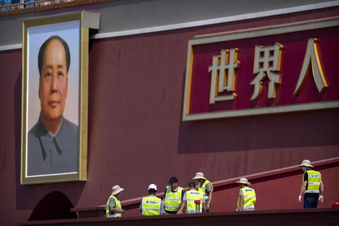 china Workers prepare a raised seating area near the large portrait of Chinese leader Mao Zedong on Tiananmen Gate near Tiananmen Square in Beijing, China. AP PHOTO/MARK SCHIEFELBEIN