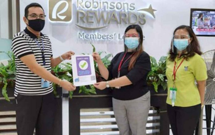 dti Department of Trade and Industry -Iloilo development specialist Kurt Maurice Tugaff (left) awards the Safety Seal to a supermarket in Pavia, Iloilo, on June 17. The Safety Seal is an affirmation that the establishment is compliant with the minimum public health standards set by the government, according to DTI-Iloilo director Judith Degala. DTI ILOILO