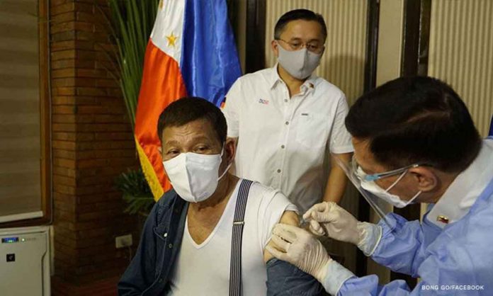 duterte Health secretary Francisco Duque III administers Sinopharm’s COVID-19 vaccine to President Rodrigo Duterte on May 3, 2021, in Malacañang. BONG GO/FACEBOOK