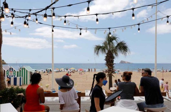 europe-pandemic People enjoy the weather on Levante beach in Benidorm, Spain. The WHO has urged Europeans to travel responsibly during the holiday season, since the continent was “by no means out of danger” in the battle against COVID-19. EVA MANEZ LOPEZ/REUTERS