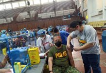 Iloilo City police director Colonel Uldarico Garbanzos receives his first dose of the Sinovac vaccine against coronavirus disease. ICPO