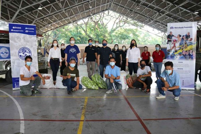 metrobank-pr Metrobank Foundation, Incorporated president Aniceto SobrepeƱa (second row standing, second from left) lead the kick-off of the four week-support for community pantries with Tanging Yaman Foundation founder Fr. Manoling Francisco SJ (second row standing, third from left). Joining them are representatives from Metrobank, Metrobank Foundation, Incorporated, Tanging Yaman Foundation, and delivery transportation partners on May 22, 2021, held at the Ateneo de Manila University in Quezon City.