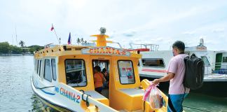 OFF TO GUIMARAS . A man boards this modernized motorboat bound for Guimaras at the Iloilo City ferry terminal. Beginning yesterday, the trips of motorboats from Iloilo City crossing the Iloilo Strait for Guimaras island-province and vice versa were extended up to 5 p.m. from the previous 3 p.m. JAPHET FAJARDO/PN