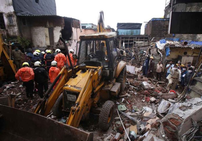 mumbai-bldg-collapse Rescuers clear the debris to find any residents possibly still trapped after a three-story dilapidated building collapsed following heavy monsoon rains in Mumbai, India on Thursday. AP PHOTO/RAFIQ MAQBOOL