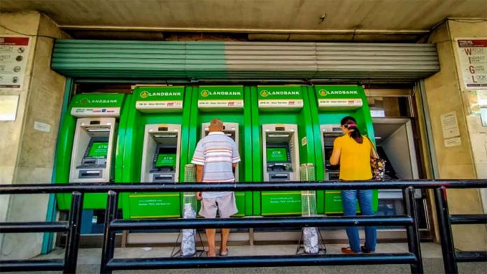 news-bank-account People transact at a bank’s automated teller machine terminal on Solis Street, Iloilo City. A panel of House lawmakers have approved House Bill 7619 or the “Bank Account Portability for Workers Act,” which allows private sector employees to choose the bank account where their wages may be deposited. PN FILE PHOTO