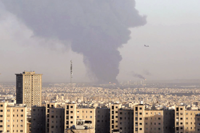 oil-refinery Huge smoke rises from an oil refinery near Tehran, Iran after a massive fire broke out Wednesday night. AP PHOTO/VAHID SALEMI
