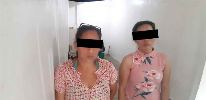 pic-scammers Renalie Lavalle (left) of Barangay Guzman Jesena, Mandurriao, Iloilo City and Marie Trexie Joguilon of Barangay Ungka II, Pavia, Iloilo were caught in an entrapment operation on Bonifacio Drive, Iloilo City yesterday morning. JAPHET FAJARDO/PN