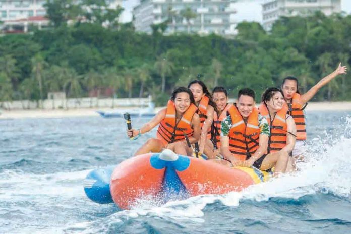 Tourists enjoy their banana boat ride in Boracay Beach, Aklan. During the 30th Visayas Area Business Conference on July 29 and 30, Department of Tourism secretary Bernadette Romulo-Puyat will unveil the roadmap on how to fully open Boaracay Island to tourist amid the health pandemic. MALAY TOURISM