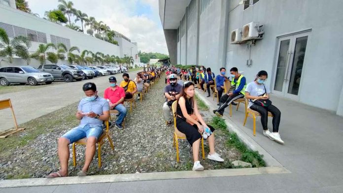 Observing physical distancing outside the Iloilo Convention Center in Mandurriao, Iloilo City, priority residents wait for their turn to be vaccinated against coronavirus disease 2019. JAPHET FAJARDO/PN