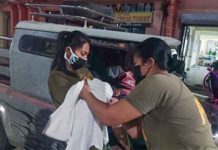 LAUDED. Corporal Mary Joy Fusin, a registered nurse, and Staff Sergeant Maybelle Legario help a mother successfully give birth in Dumalag, Capiz in this undated photo. PHOTO COURTESY OF PNP PIO