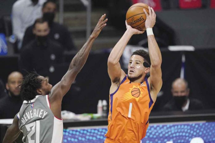 suns-clippers Phoenix Suns’ Devin Booker (right) shoots over Los Angeles Clippers’ Patrick Beverley (left) during the first half of Game 4 of their Western Conference Finals on Saturday. AP PHOTO/MARK J. TERRILL