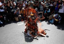 Thai protesters back on streets to demand constitutional changes Members of the media take photos of a model of Democracy Monument set on fire by protesters before a march to mark the 89th anniversary of the abolition of absolute monarchy in Bangkok, Thailand, on June 24, 2021. REUTERS/SOE ZEYA TUN