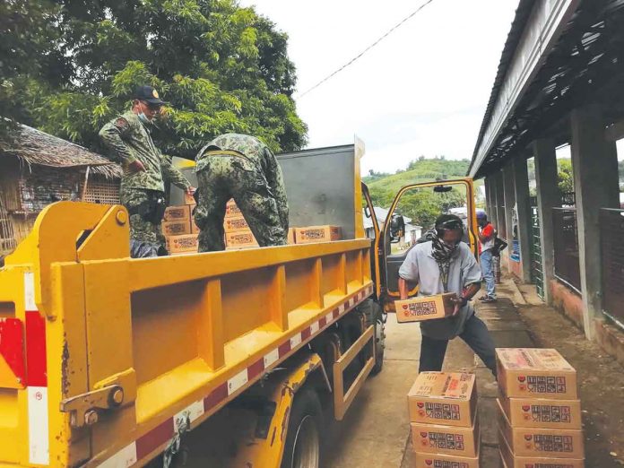 Delta Volunteers unload boxes of relief goods from the Department of Social Welfare and Development for residents affected by the enhanced community quarantine in Batad, Iloilo. The province of Iloilo is currently under the strictest lockdown due to a surge in COVID cases. DSWD-6